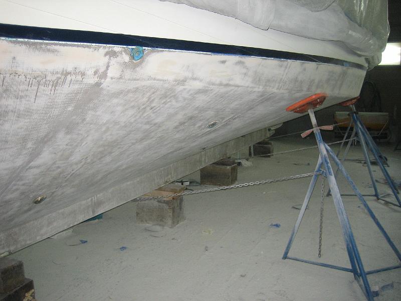 APRIL 22, 2009 003.jpg - Photo shows that they leave very little fairing material on the boat before painting.